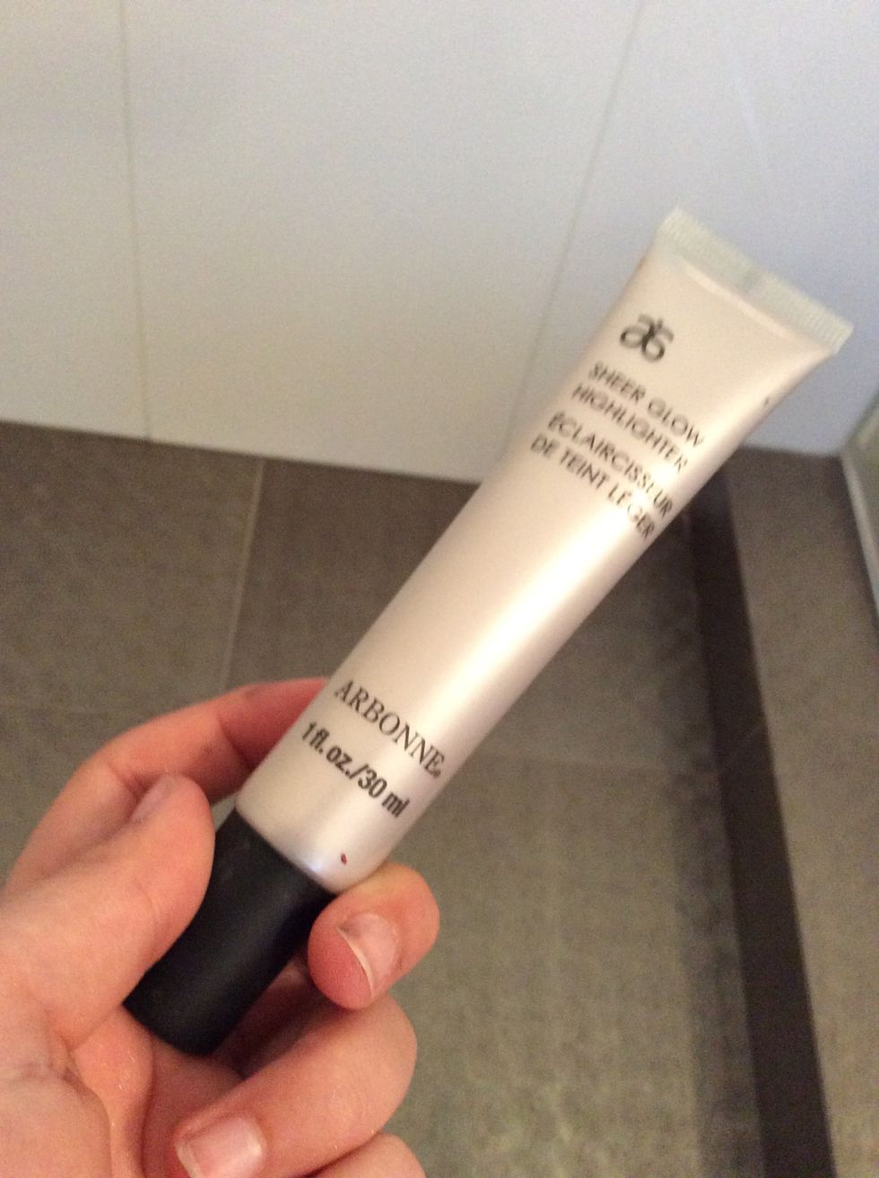 Now I'm going to apply this highlighting cream (you can use powder if you want) on the bridge of my nose and around my under eye area.