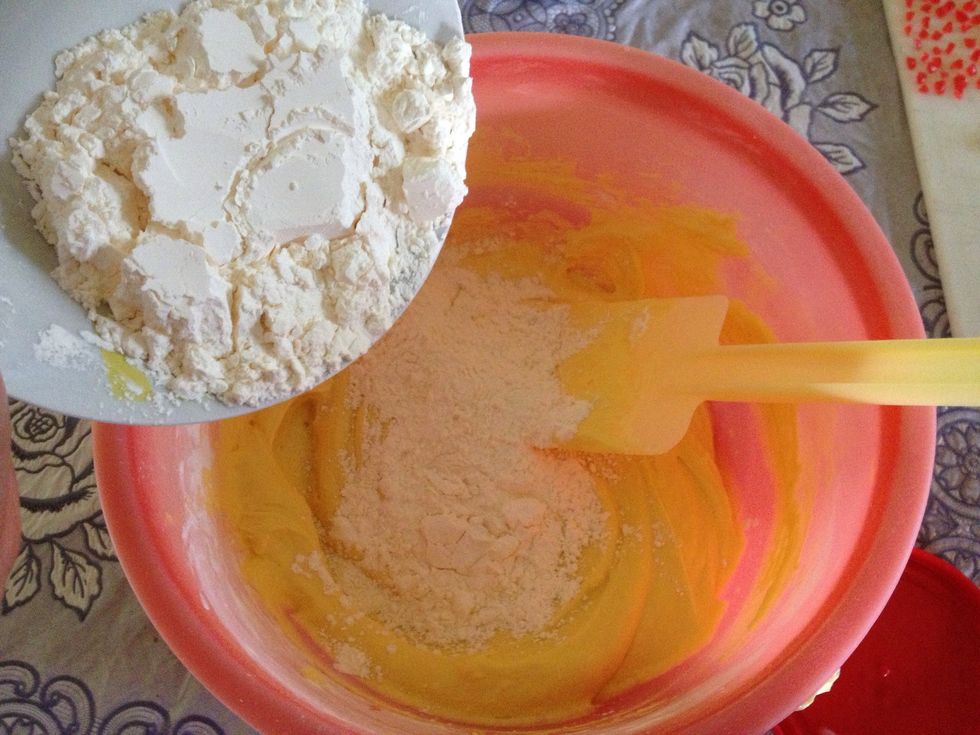 Now, if you are using a mixer like me, keep those away n get a spatula. Add custard powder into the mixture and fold them well with a spatula. You can add bit by bit.