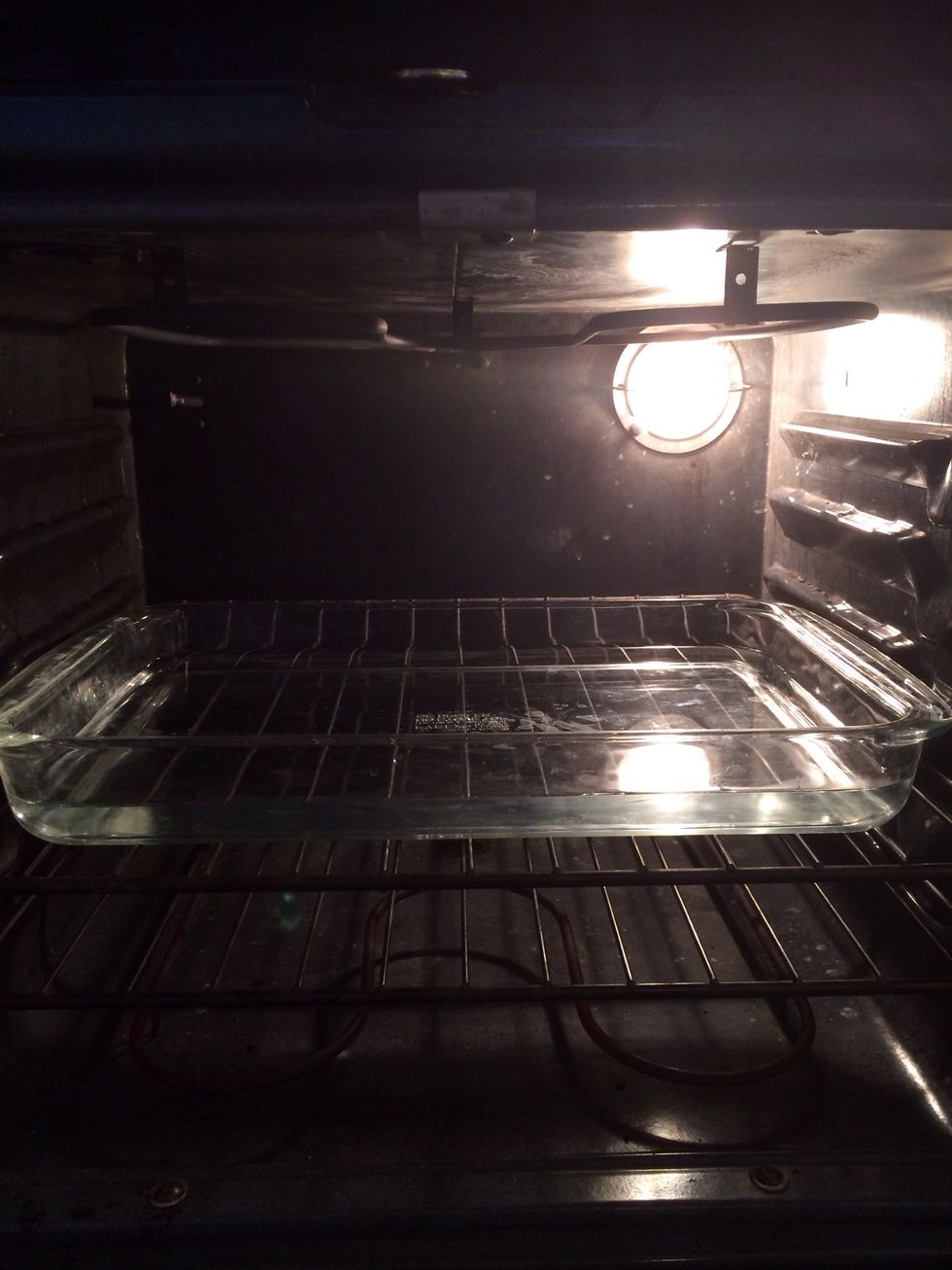 Now it is time for the "Ba\u00f1o Maria":  Fill a large casserole dish about half way with water.
