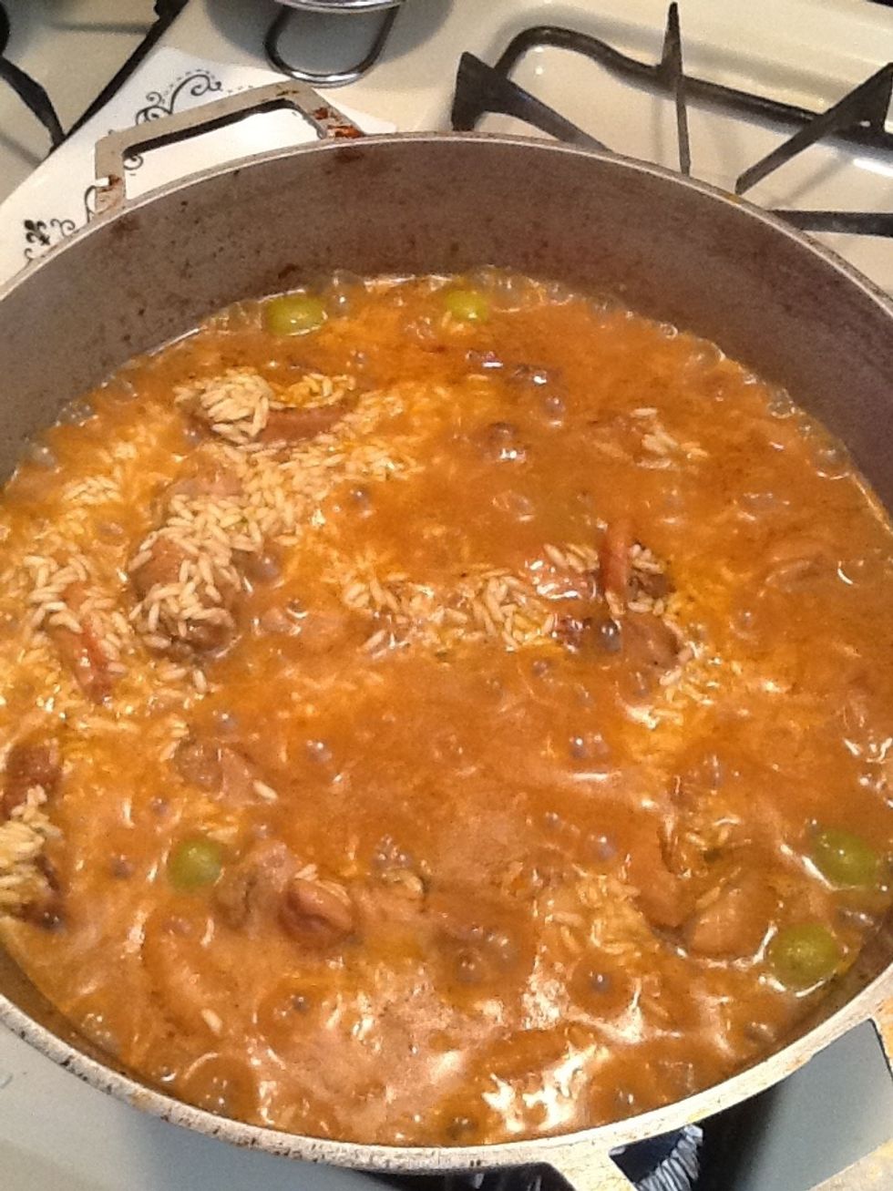 Now it's the waiting game. We will wait for the rice to absorb all the liquid. Don't stir at all