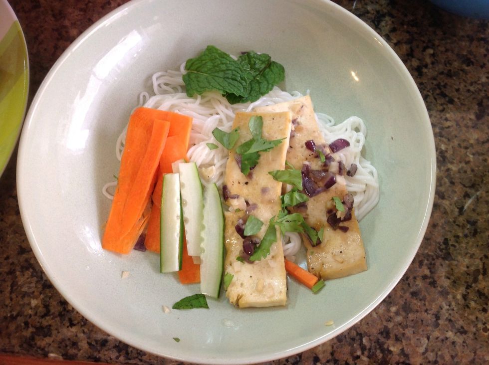 Now it's time for the assembly. Add as much vermicelli noodles as you would like. Add julienned cucumbers and carrots. Add cilantro, mint, and coriander to taste. Add the saut\u00e9ed tofu.  Bon appetit!