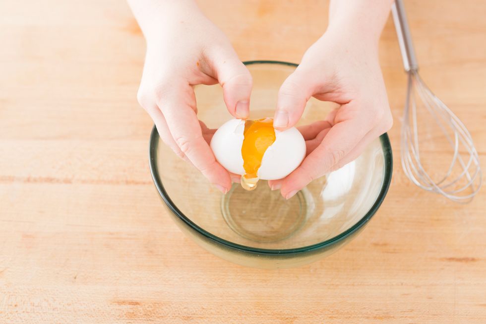 Now it's time for the cream cheese! We'll start the same way by cracking one egg into a large bowl.