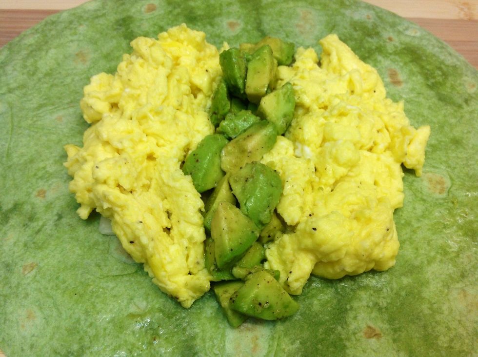 Now it's time to add your scrambled eggs and chopped avocado you have already prepared. I like to put the avocado in the middle of the eggs but do as you please on this step :)