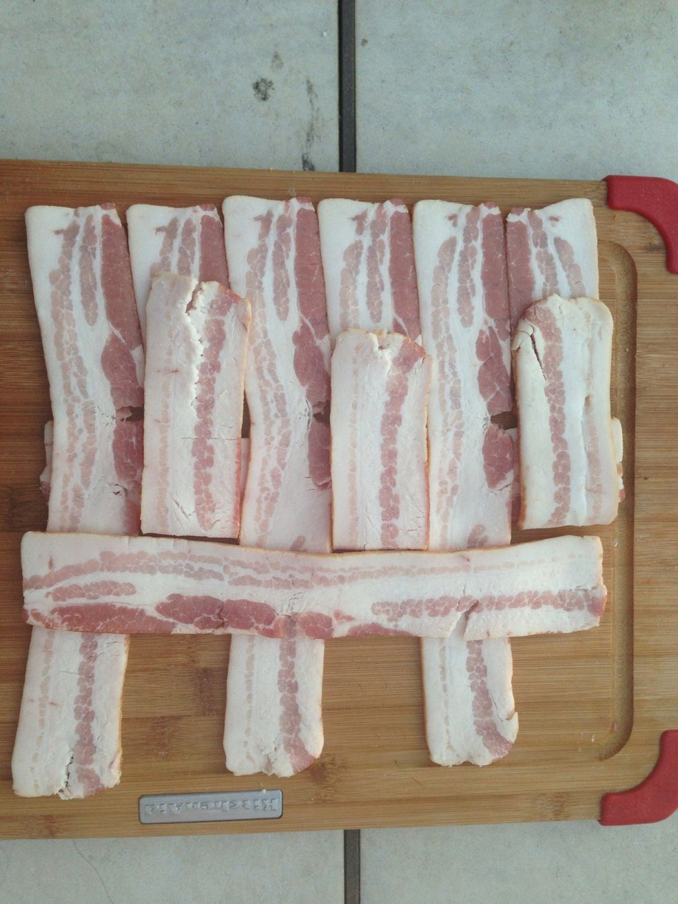 Now it's time to make the bacon weave. Lay out five or six strips of bacon horizontally on a flat surface. Then peel back every other layer and place a piece of bacon vertically.
