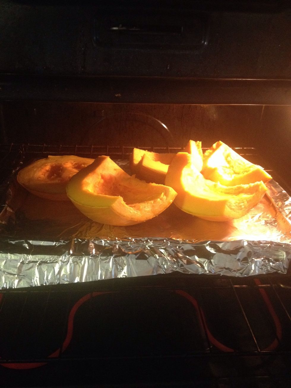 Now it's time to put your pumpkin pieces into the preheated oven. Set the timer for 90 minutes and while you're waiting, you can make a crust dough.