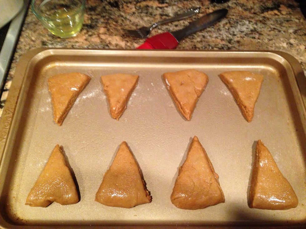 Now it's time to use that egg white. Give it a good stir and spread on top of the slices. Then sprinkle some regular sugar on top. Pop them in the oven for about 12-15 minutes.