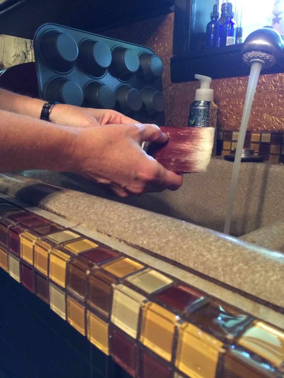 Now it's time to wash the brushes. Use WARM water, not hot and dish soap and rub the soap into the brush. "Paint" one hand using soap and rinse. Continue this until the brush is clean.