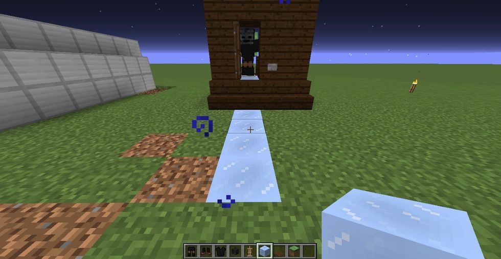 now its almost done. in front of the door place a packed ice 4 blocks coming out. purpose of the ice is to make armor stand can slide out. if we use normal block, it will not pop out. it will not move