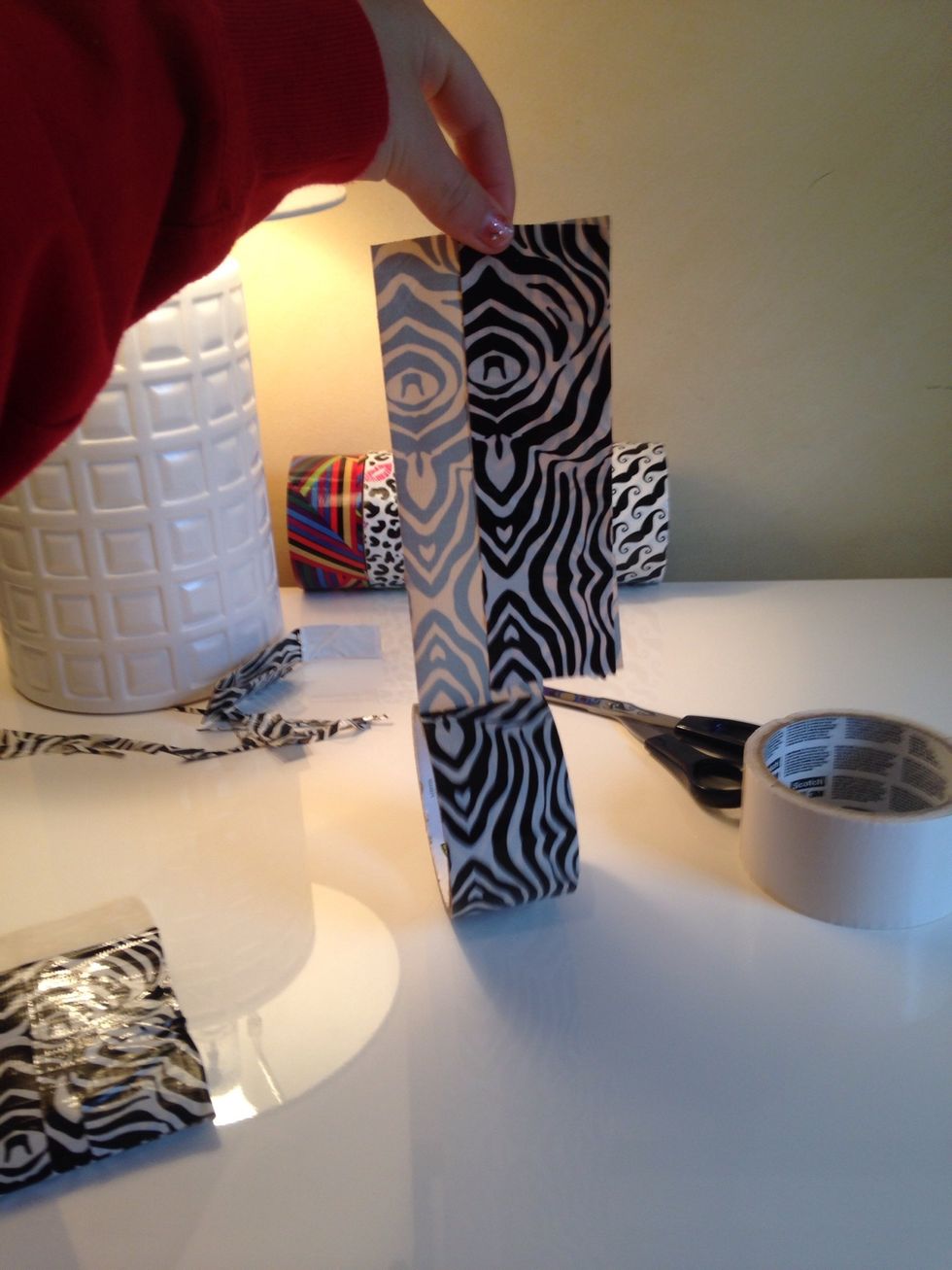 Now just take that and put it against the roll of tape, cut at the end and repeat this on the other side