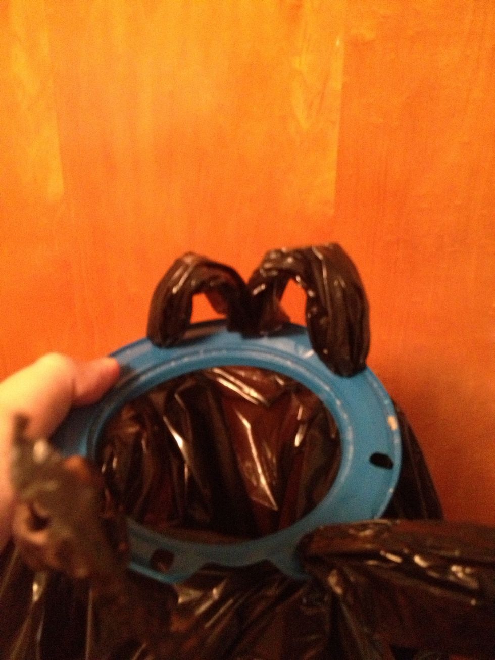 Now just twist two of the flaps together and tuck them down through the hole between them. This just helps make sure the bag doesn't slip down in. Do the same with the other two flaps.