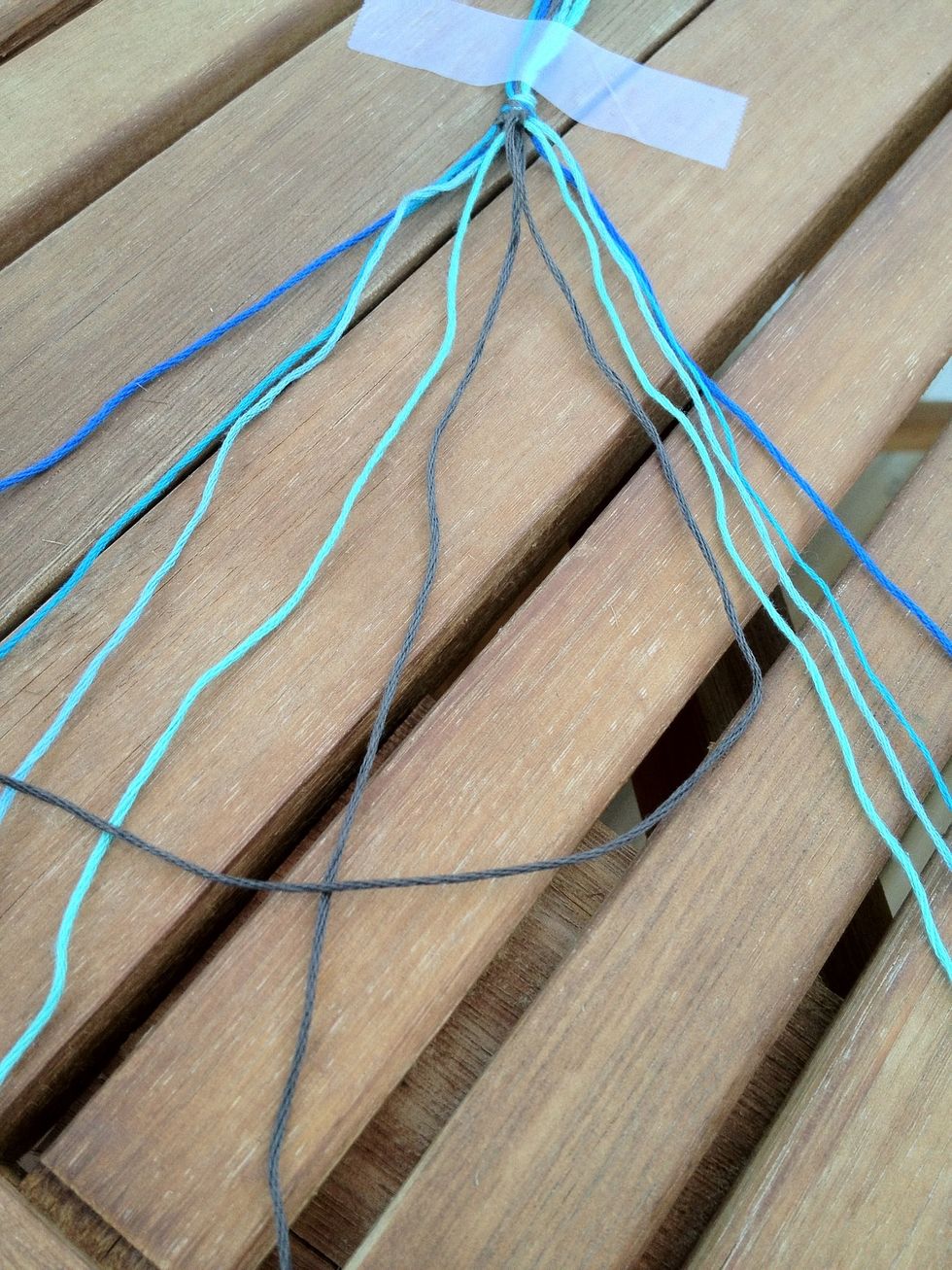 Now knot the 2 middle strings together. These should be the first strings from either side before. It doesn't matter which direction you knot them. I personally did the right hand knot.