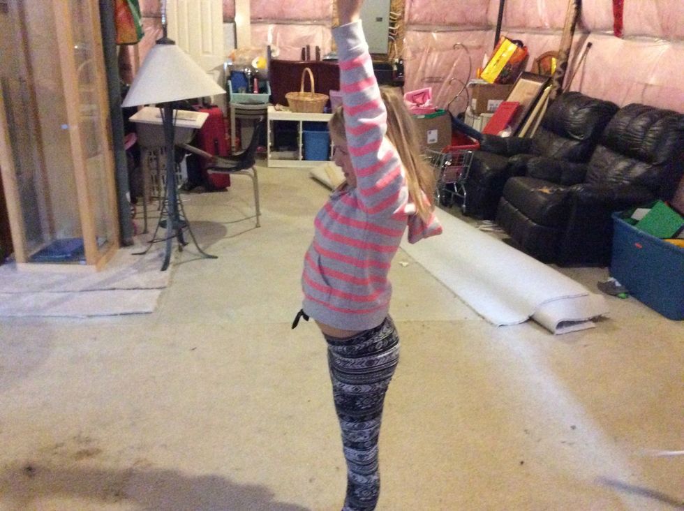 Now land with both feet on the ground and end with your hands up