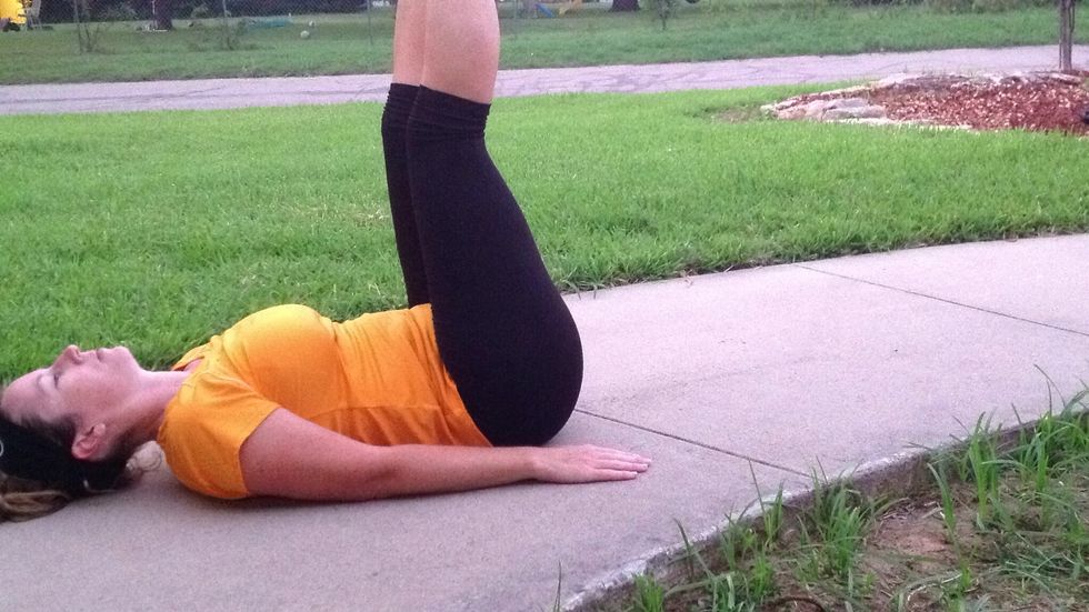 Now lay back and raise both legs to 90 degrees. Lift your rear straight up off the ground. Try to make your feet go straight up to the sky. Don't bring them to your face as you lift up.