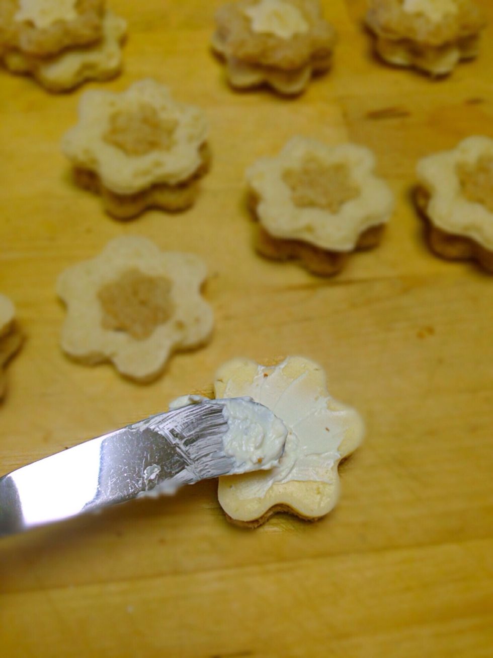 Now lay the cheese slice and spread the cream cheese to make it stick to the top bread flower