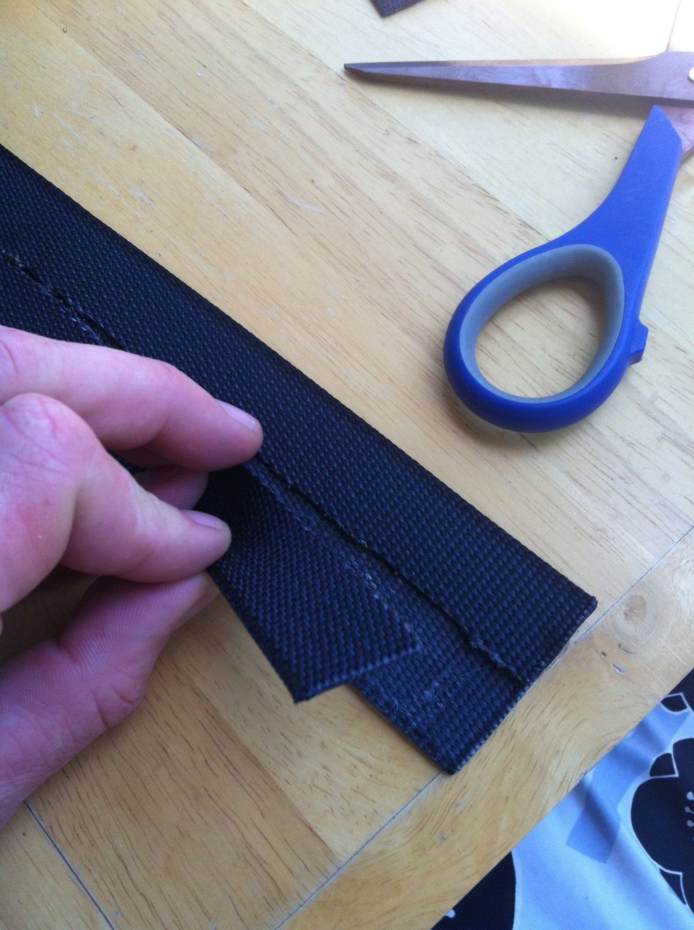 Now lay the trimmed piece on top of the other strap and cut up the middle to the same length.