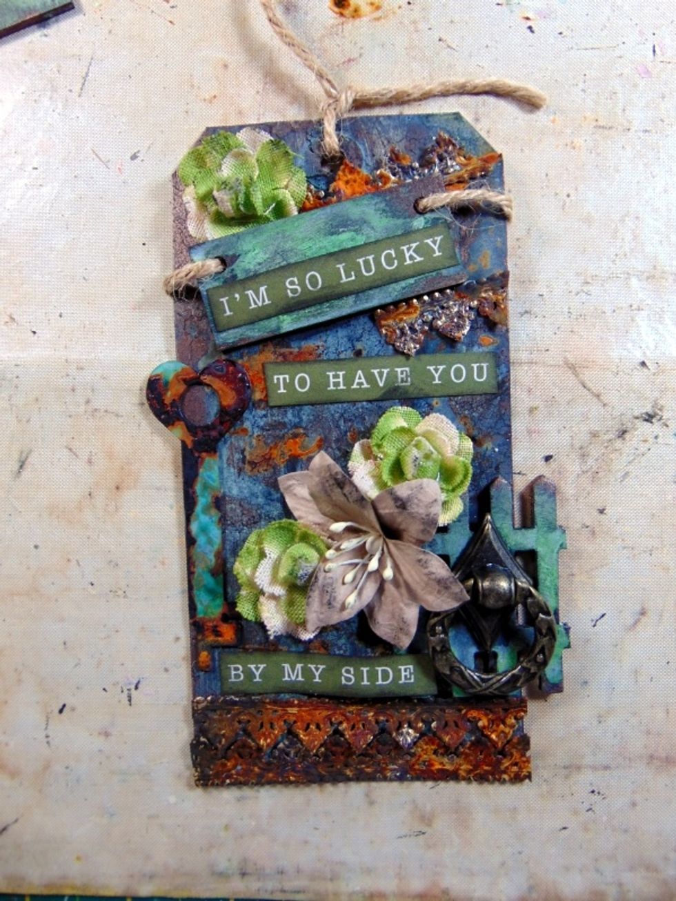 Now layer up all your gorgeous altered pieces and add some flowers and the metal door knock piece from the August kit to finish off.