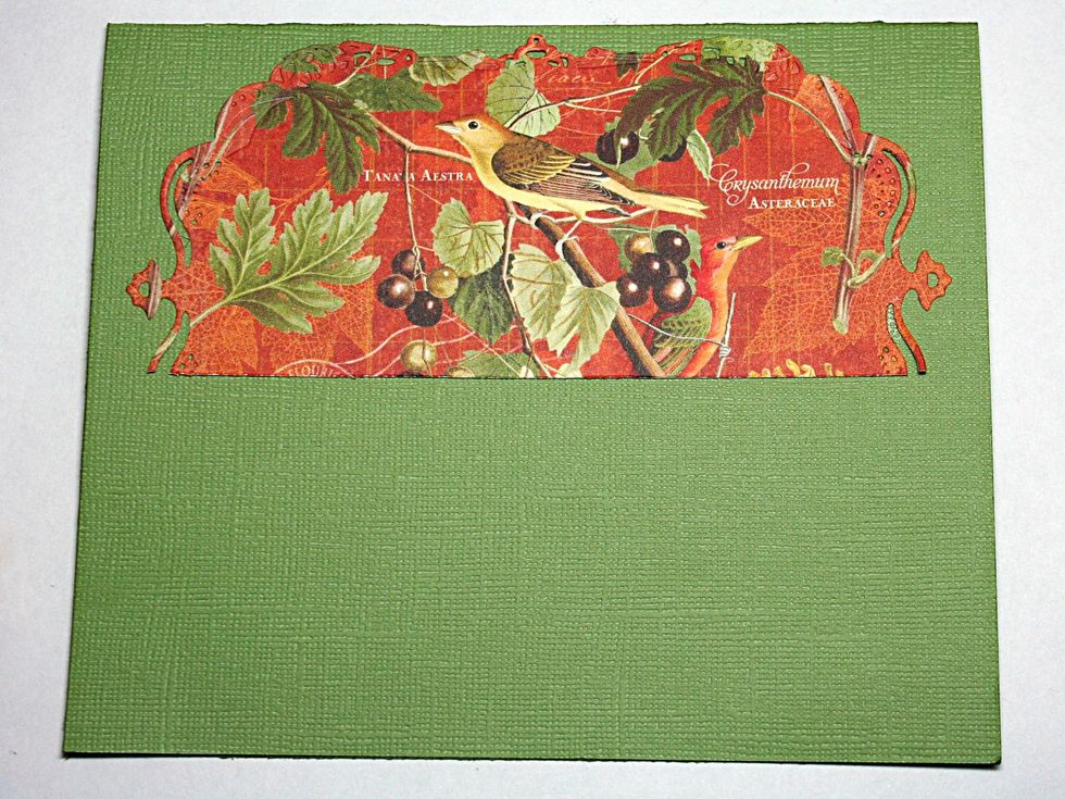 Now let's build our layers. First add the diecut frame near the top. Ink and distress your edges if you desire.