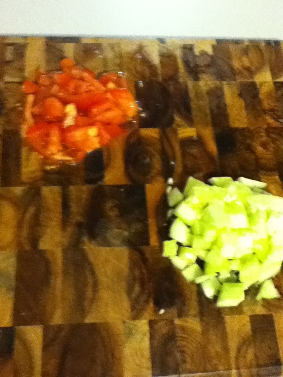 Now let's do the salad, dude. Chop a tomato and half a peeled cucumber. Squeeze the water out...