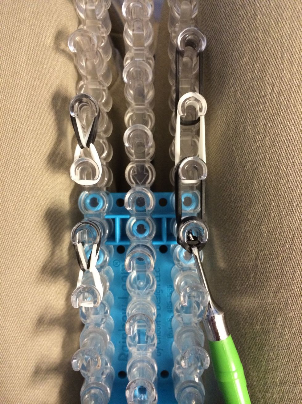 Now let's loop the nose. Reach in and grab the 1st set of bands and loop them forward. Continue for the next 2 bands.