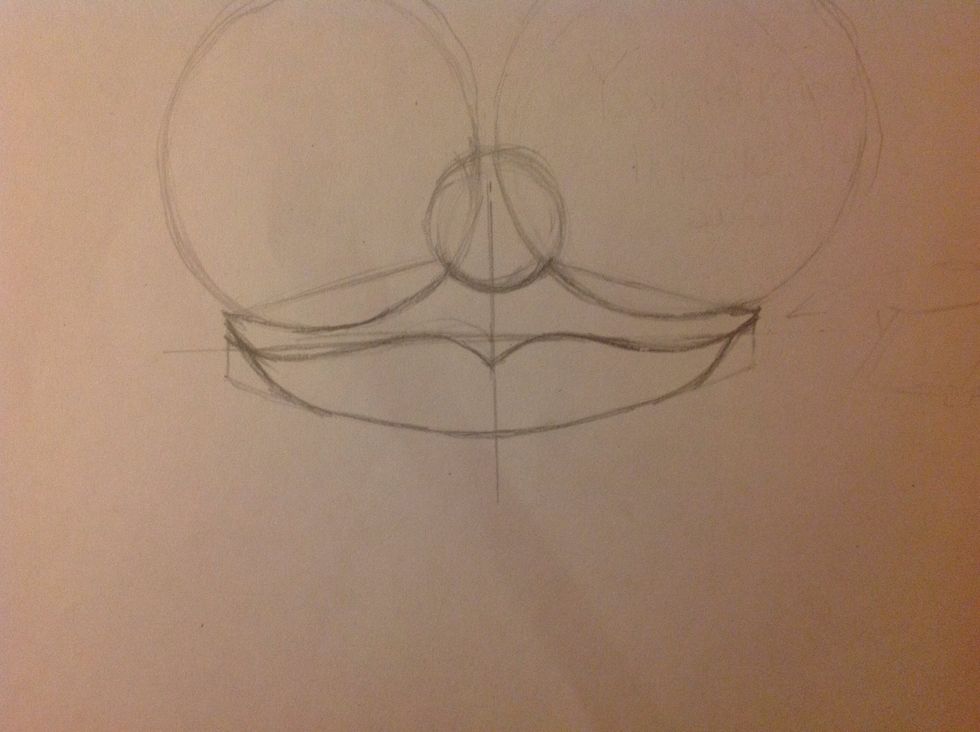 Now let's shape, join the lips at each end. The lower lip end before the top lip.