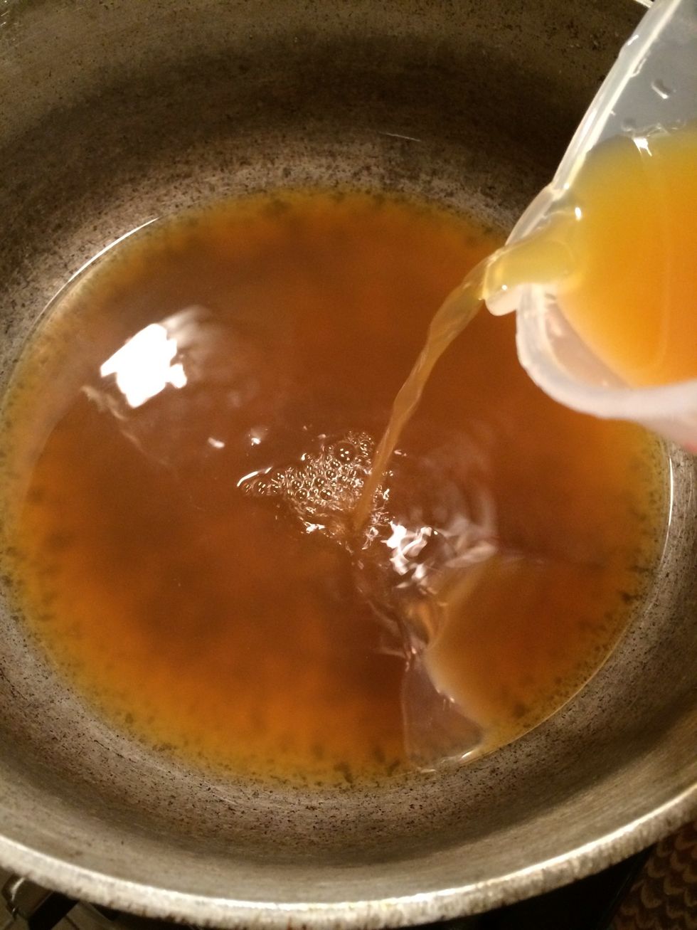 Now let's work on the sauce, take the broth and put it in a pot over medium heat.