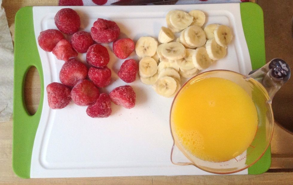 Now lets begin with at least a handful of fresh or frozen strawberries,one banana chopped into slices,and 1-2 cups of orange juice
