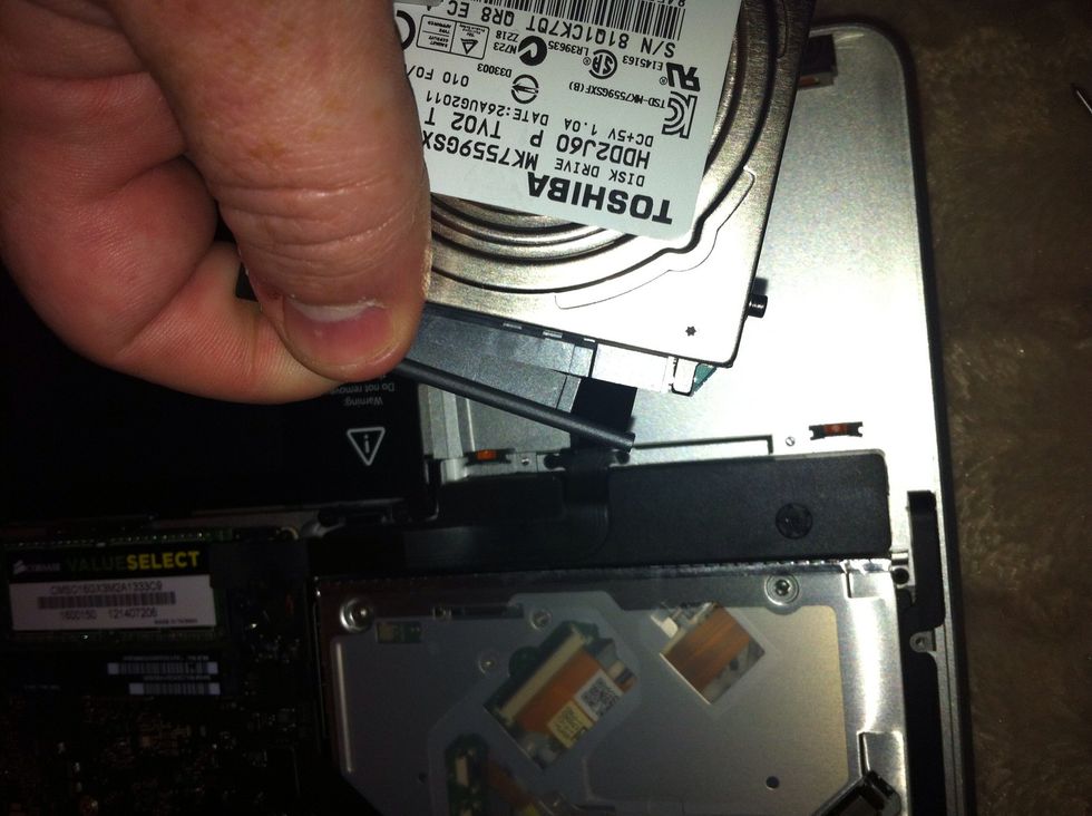 Now lift hard drive out from left and disconnect
