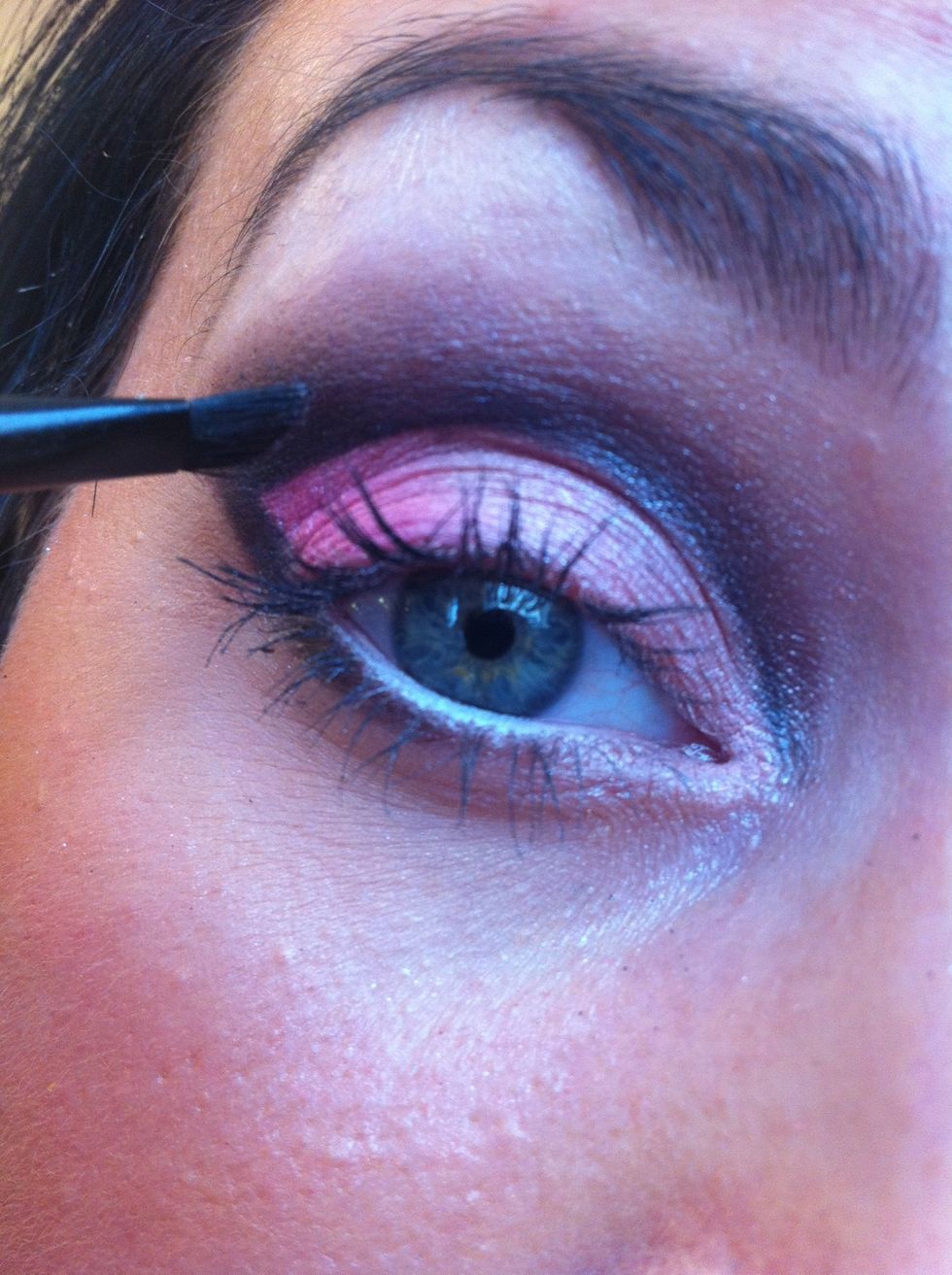 Now load an angled brush with a brown eyeshadow to set that crease line and then slightly bring the shadow outwards from the crease line.