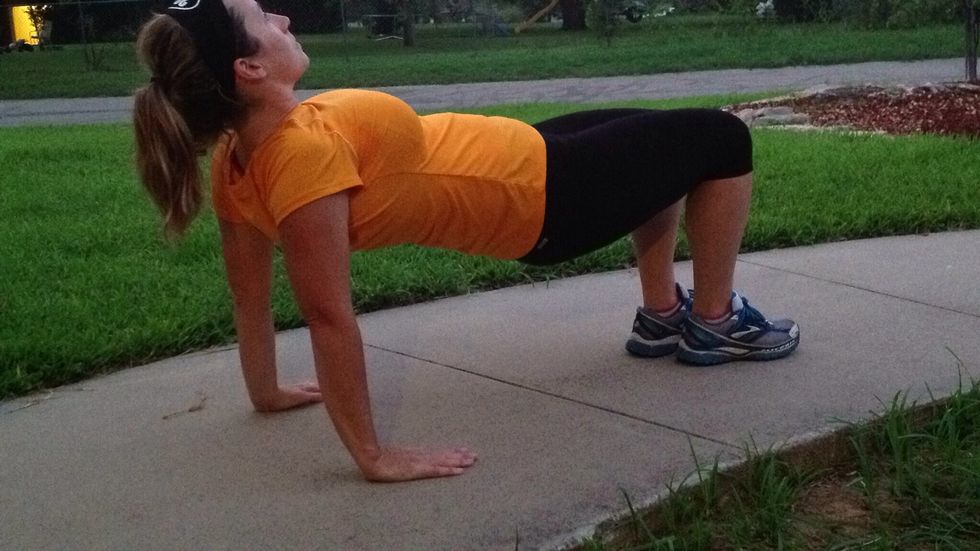 Now make a bridge. Keep your abs tight and lift your rear high. Hold while you count to five. If this is too easy, lift one leg straight out and pulse for 10. Change legs and pulse for 10.