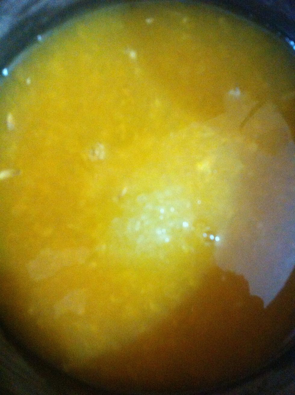 Now make orange syrup to moisten the cake before putting on mousse. Juice 2 oranges again. Put it in a pan to heat up. Add sugar. Let it cook for few minutes