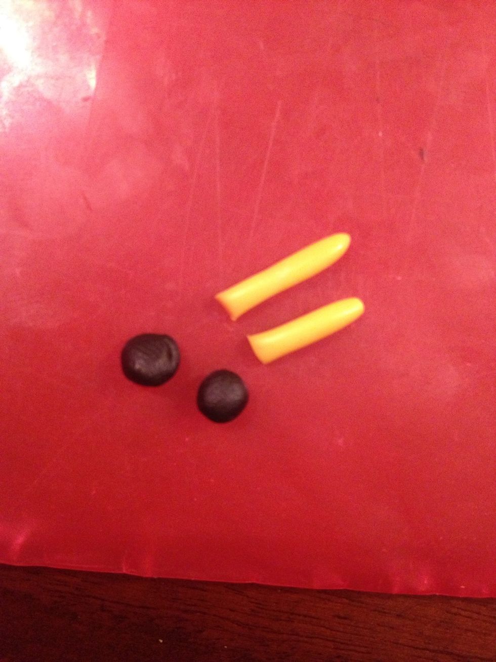 Now make two short yellow canes and two black balls - arms.