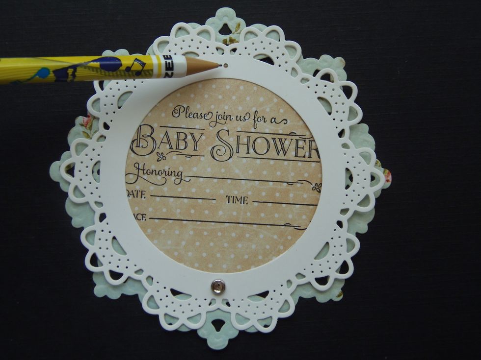 Now mark the top center of the small doily. This time ONLY punch the hole through the smaller doily.