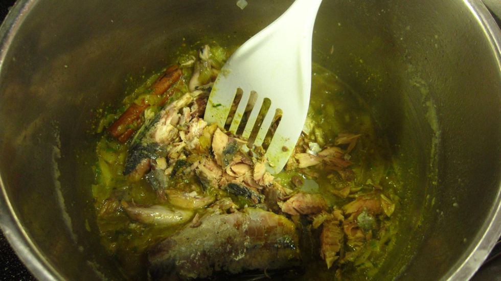 Now mash the fish using a flat spoon like this. You want a nice fine smooth mash.