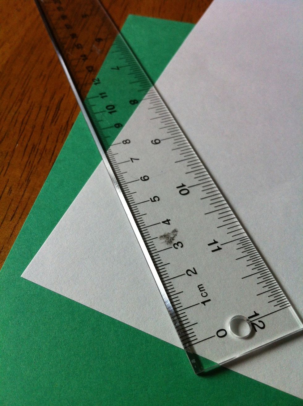 Now measure (7.5cm) and draw a line by one of the corners on the white piece of paper.