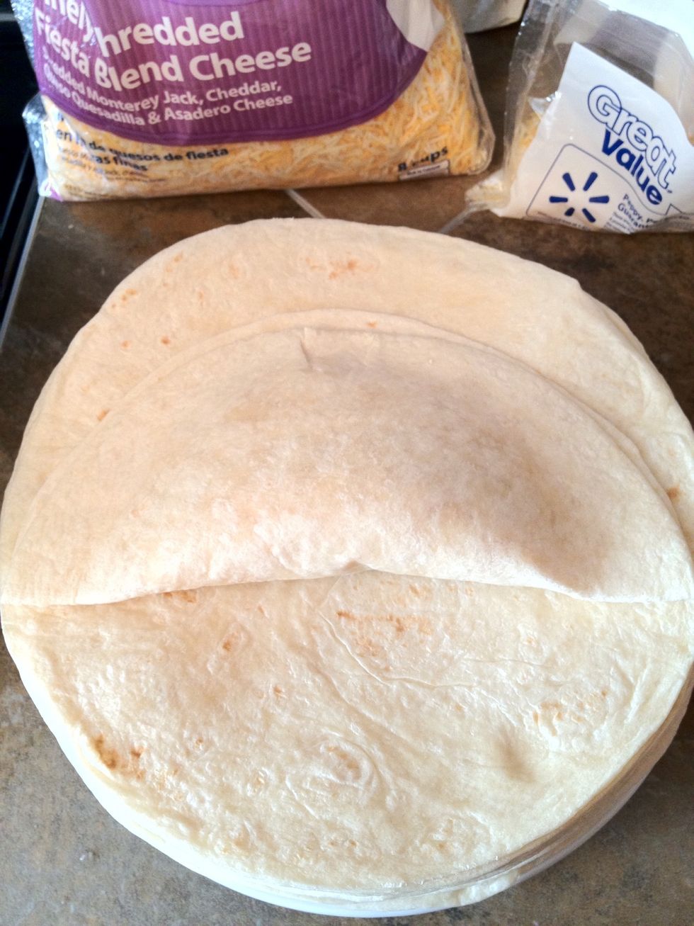 Now, most people can't fold a burrito to save their life, and most of them work as Chipolte. Step 1: fold the bottom up, just short of the top. Use your hands to kind of form it around the filling.