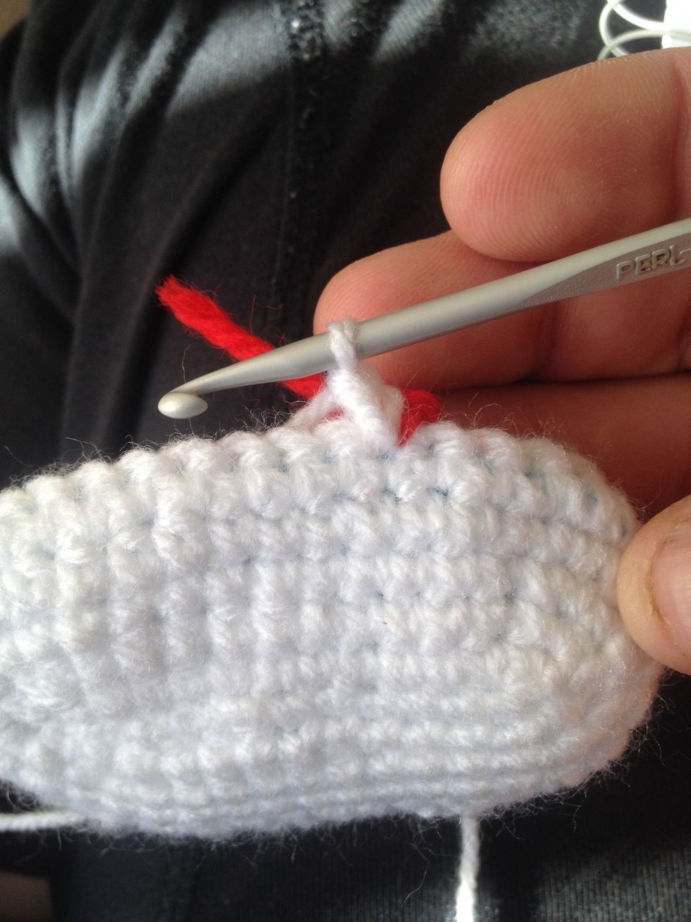 Now move over to left side. Take tan and slip stitch into the 7th stitch where the red yarn marker is and then do a single crochet into same 7th stitch where you made the slip stitch