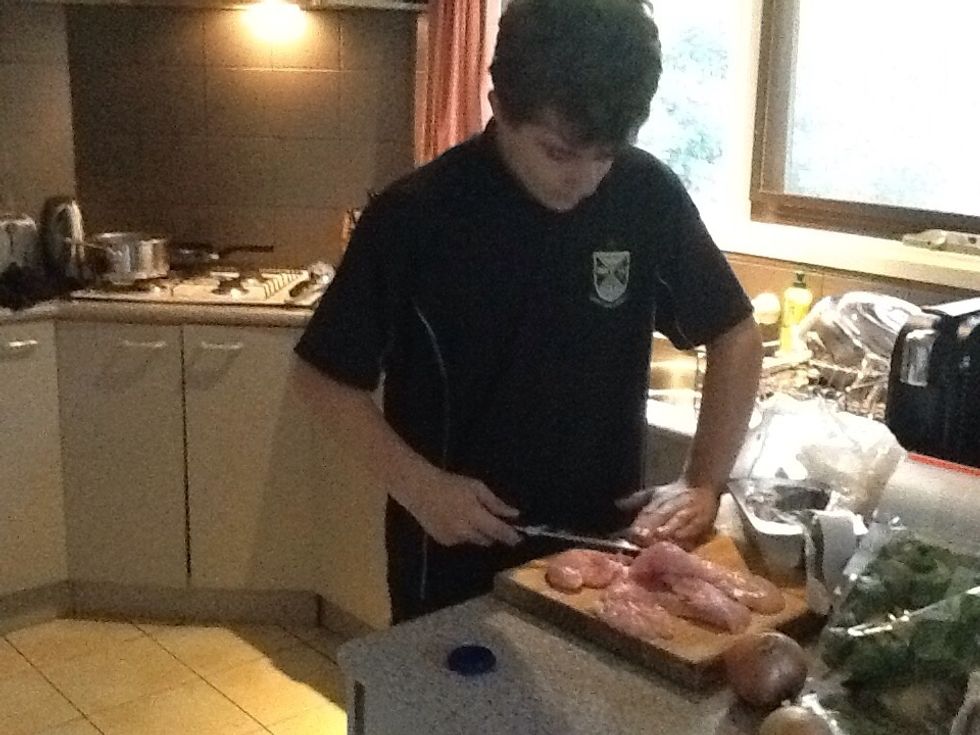 Now, moving on to the chicken, cut the breasts in half.