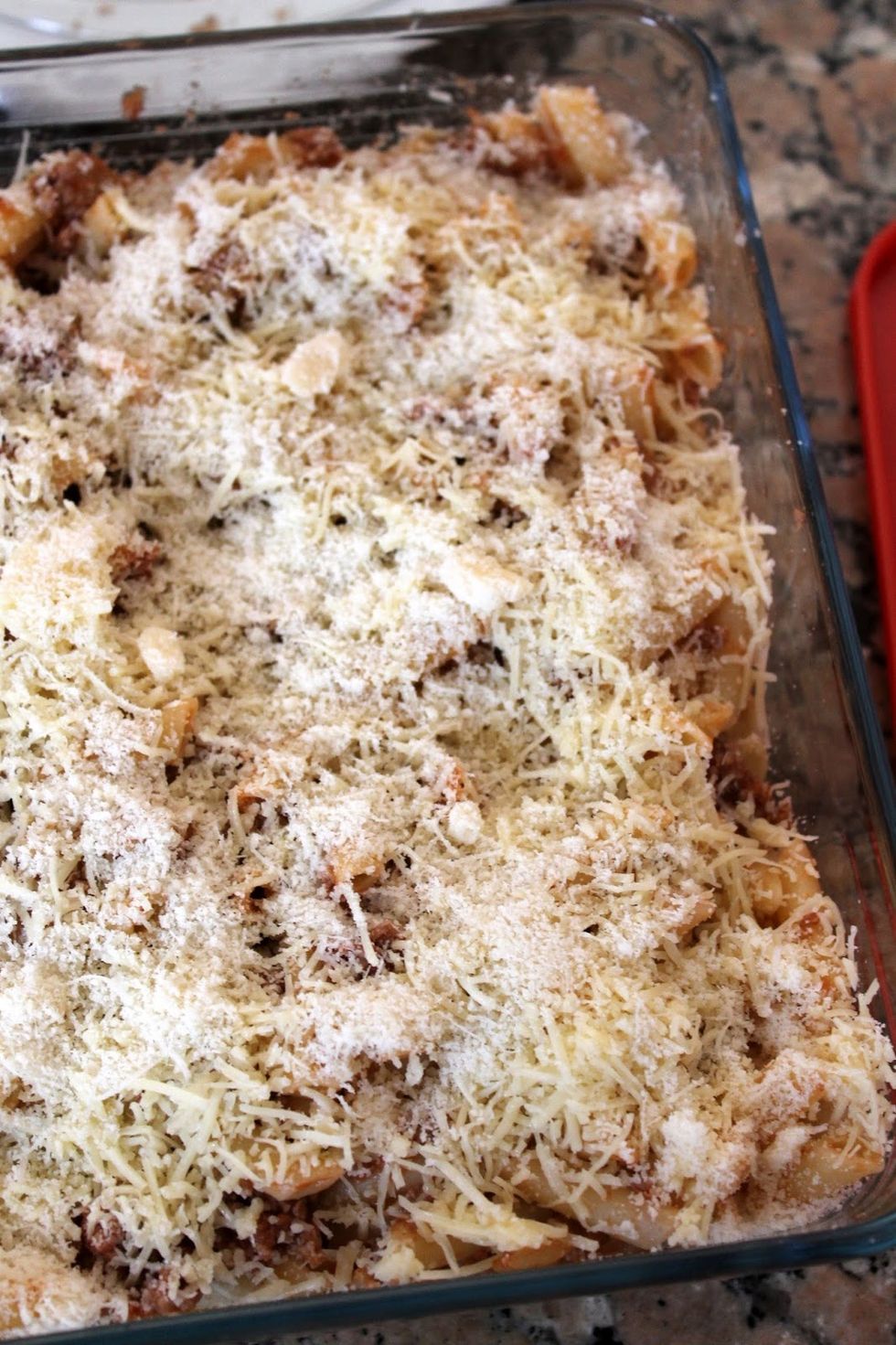 Now need to mix the pasta with Bolognese sauce in a glass tray and add the grated cheese and gratinamos few minutes in the oven