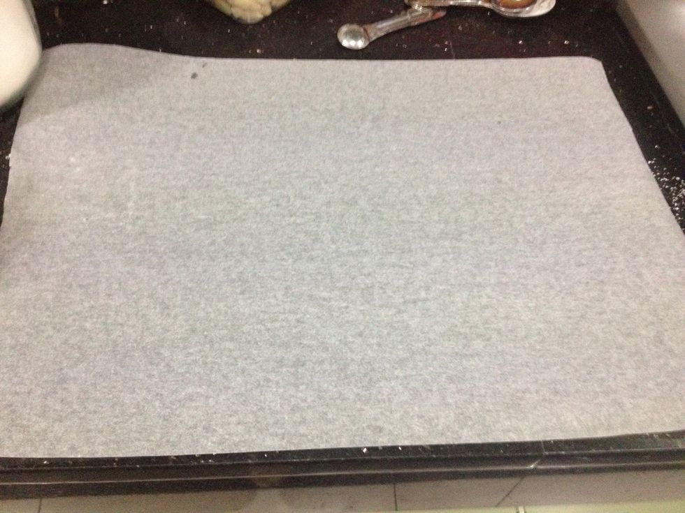 Now on a clean work surface, place a piece of parchment paper, the same size as the Swiss roll pan.