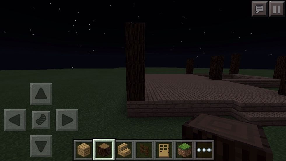 Now on each corner, build up a pole 4 blocks up high using spruce wood blocks.