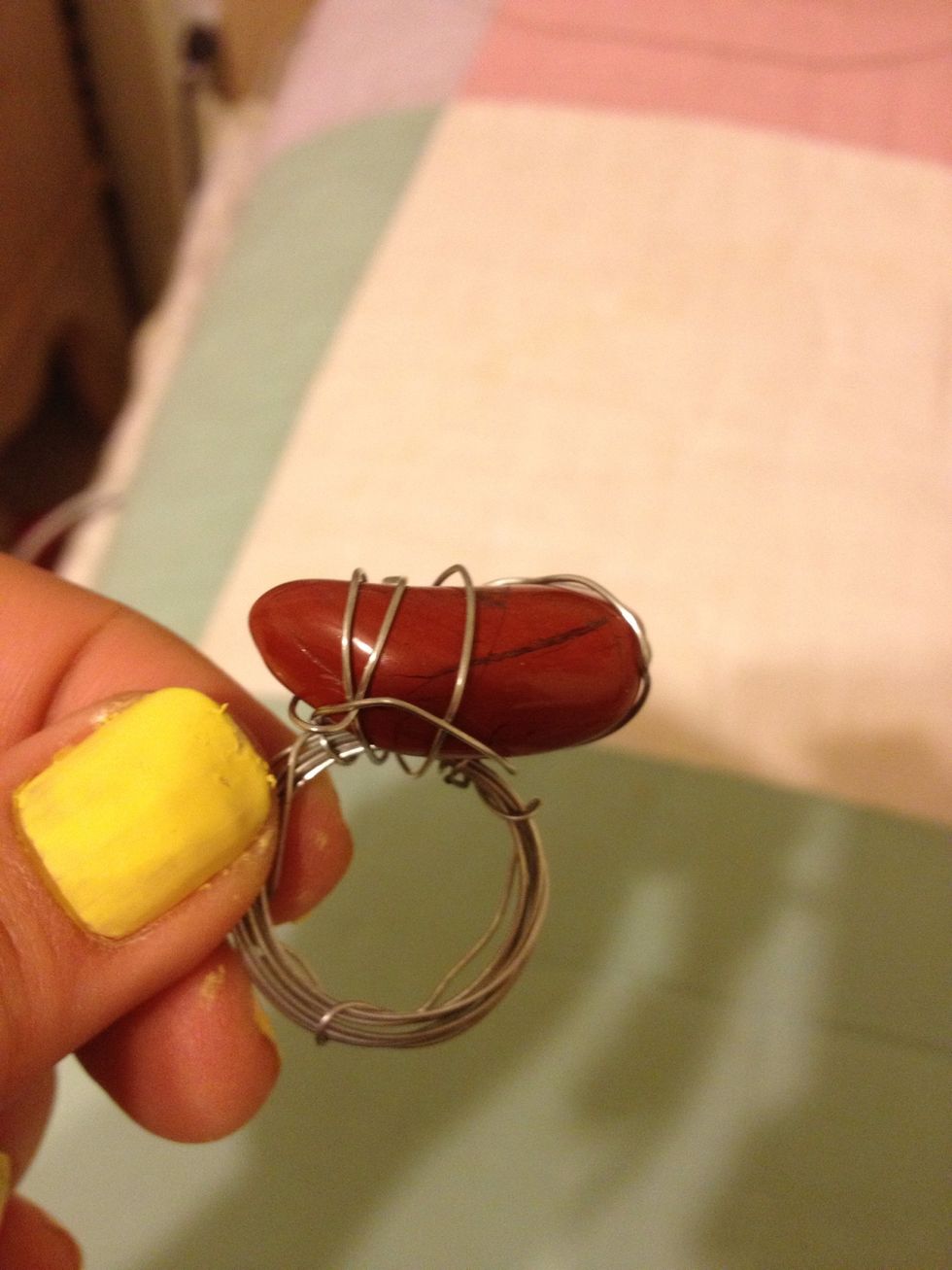 Now on the part where you first wrapped the short end around the bunch, place the stone there. You can either hot glue it in place or strategically wrap the wire around it and secure it in place