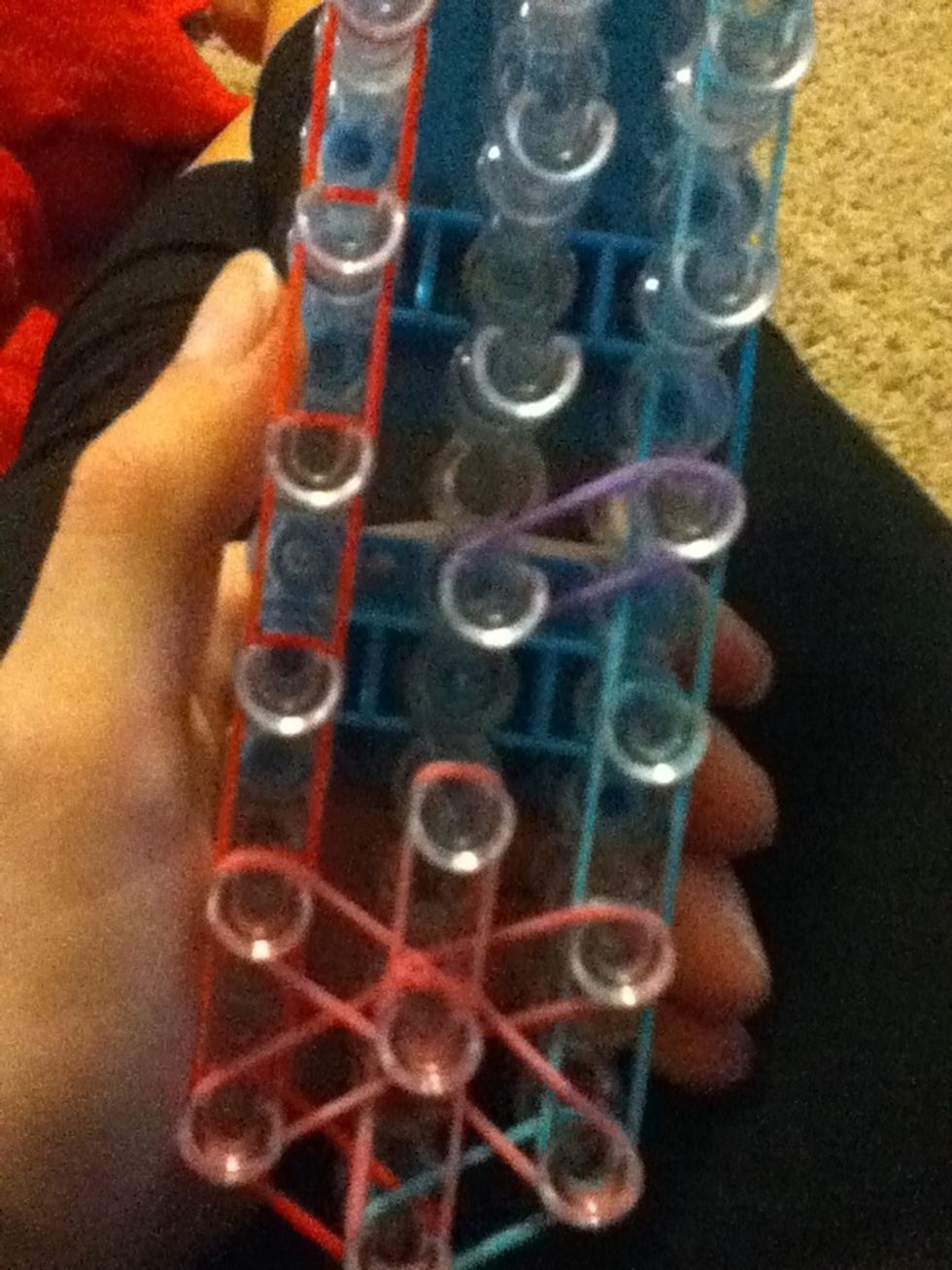 Now on the right side put a band on the two pegs