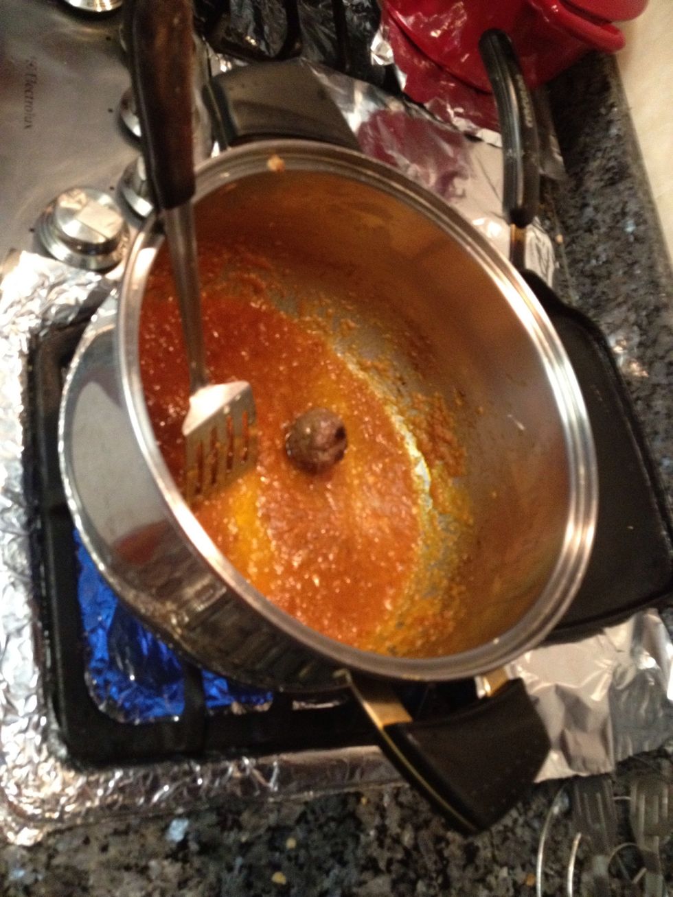 now once the mixture is Cooked a little for about 10 mins. (should look like this color) and meatballs have been cooked; add all the meatballs to the pan with the blended onion mixture..