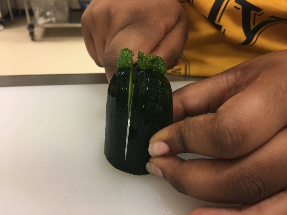 Now once you stand it up cut the Zucchini on one side, all the way down.