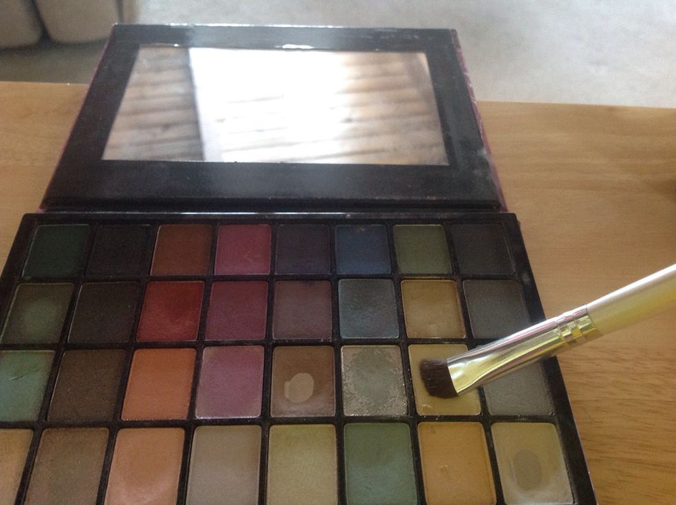 Now onto eyes! I am taking this shimmery gold color and putting it all over the lid