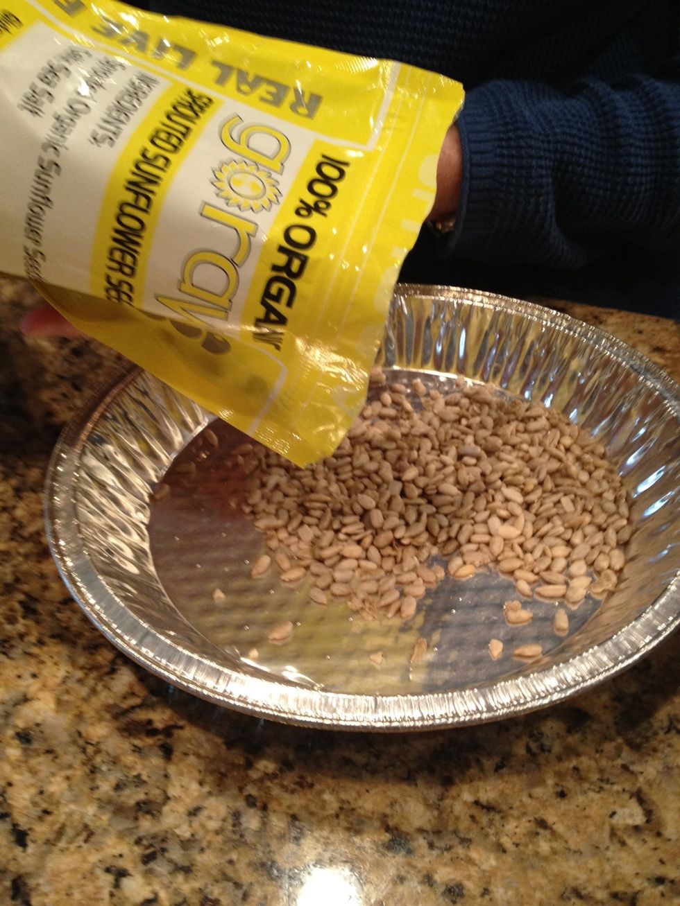 Now onto the seeds! Add 1/3 cup of sunflower seeds to a pie pan.