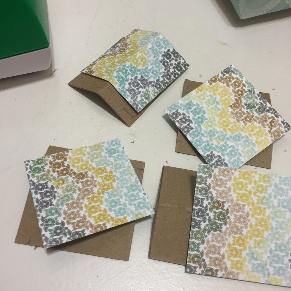 Now over those 4 corners you but out with contrasting paper, and glue down, right after you glue, bend that fold into it so the paper dried in the 90 degree angle shape