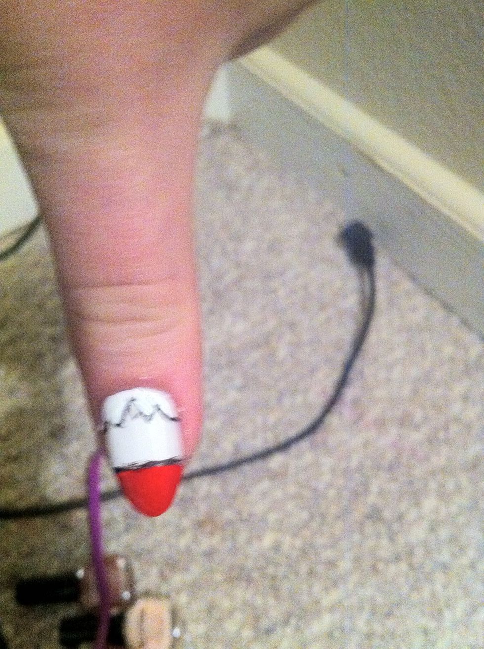 Now paint a black line above the red part of you nail, separating it from the white. Also paint a mountain outline, with three points; two small ones and a big one in the middle.*sorryfortheblurrypic