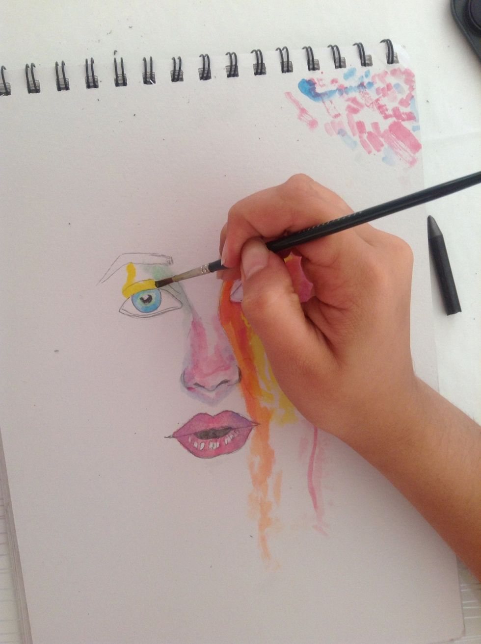 Now paint some yellow and green above the left eye.