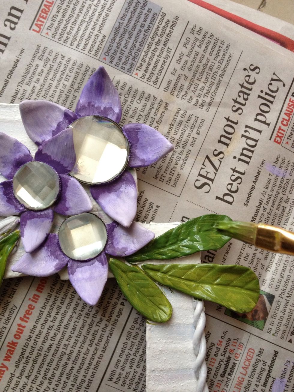 Now paint the flowers and the leaves. You can give light and dark highlights like I have done. Whatever looks good. Remember to use contrasting colors.